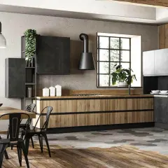 Cucina stile industrial con mobili in legno e metallo, isola centrale e tavolo da pranzo.