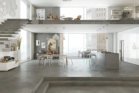 Interni moderni con cucina a isola, zona pranzo e soppalco. I **colori resina cucina** dominano il pavimento e le superfici, creando un ambiente minimalista e sofisticato.