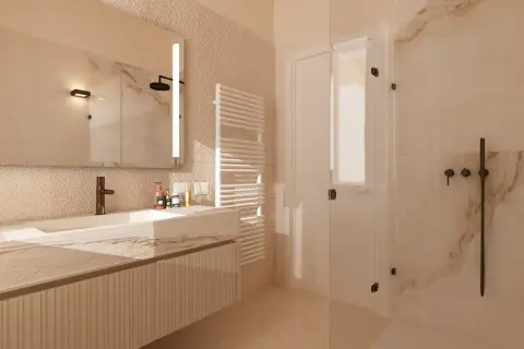 Un bagno elegante e raffinato con lavabo in marmo, specchio illuminato, doccia in cristallo e scaldasalviette.