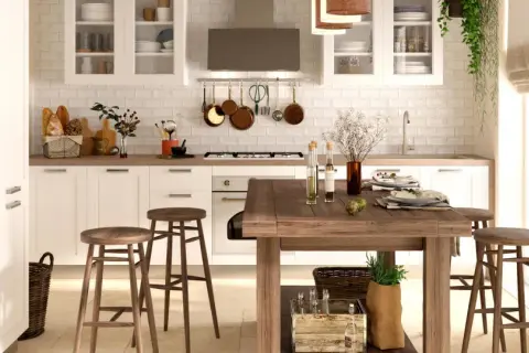 Cucina luminosa con pavimento in cotto, mobili bianchi, isola in legno e dettagli rustici. Perfetti abbinamenti cucine con pavimento in cotto per un ambiente caldo.