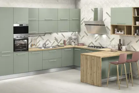 Elegante cucina verde malva con isola in legno, elettrodomestici in acciaio e sgabelli rosa.