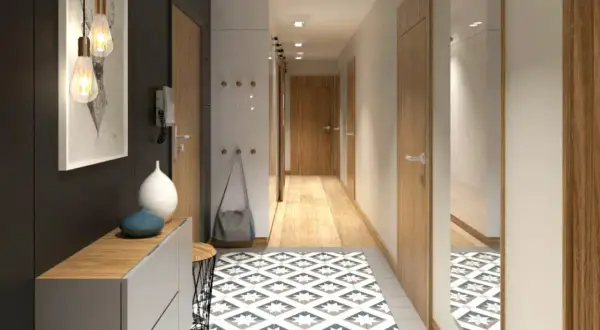 Un corridoio moderno e accogliente, perfetto per arredare con stile. Tappeto geometrico, mobili essenziali e luci d'atmosfera creano un'entrata invitante.