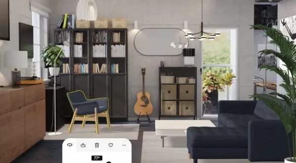 Arredamento studio casa: soggiorno moderno con divano blu, librerie, poltrona, chitarra e un pannello di controllo temperatura.