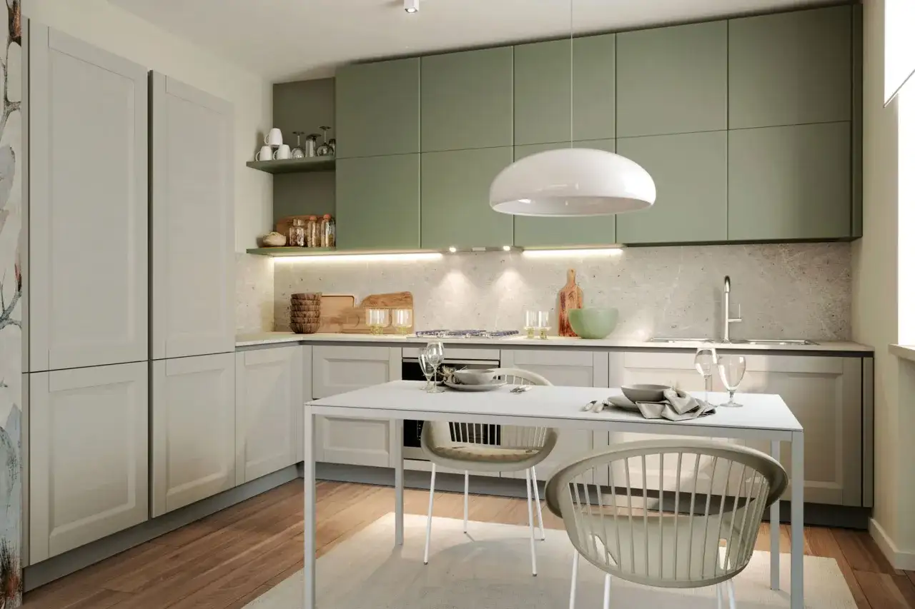 Un moderno angolo cucina con pensili verdi, piano di lavoro in marmo e un tavolo bianco con sedie.