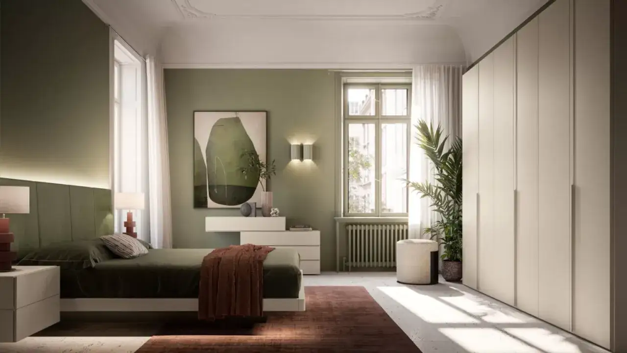 Camera da letto con pareti verde oliva, letto comodo, armadio bianco e un quadro astratto.