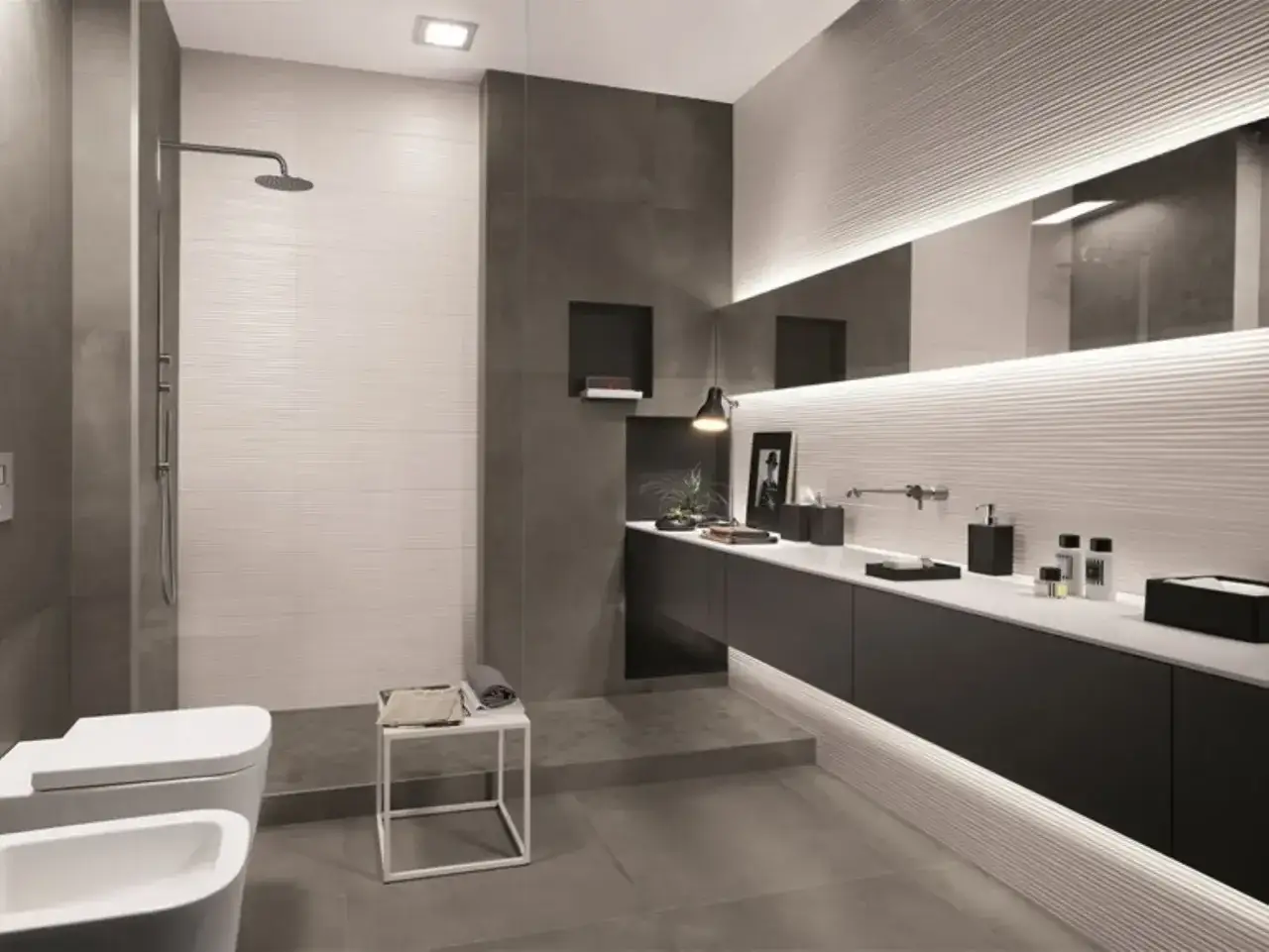 Bagno moderno con doccia in muratura, lavabo, bidet e mobile sospeso con specchio illuminato.