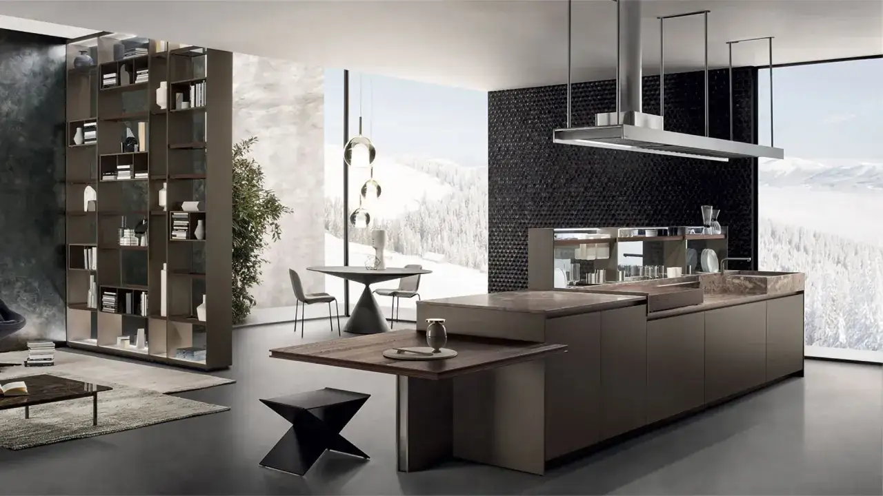 Ispirazione per come progettare una cucina moderna: isola centrale, libreria a giorno e vista panoramica su paesaggio innevato.