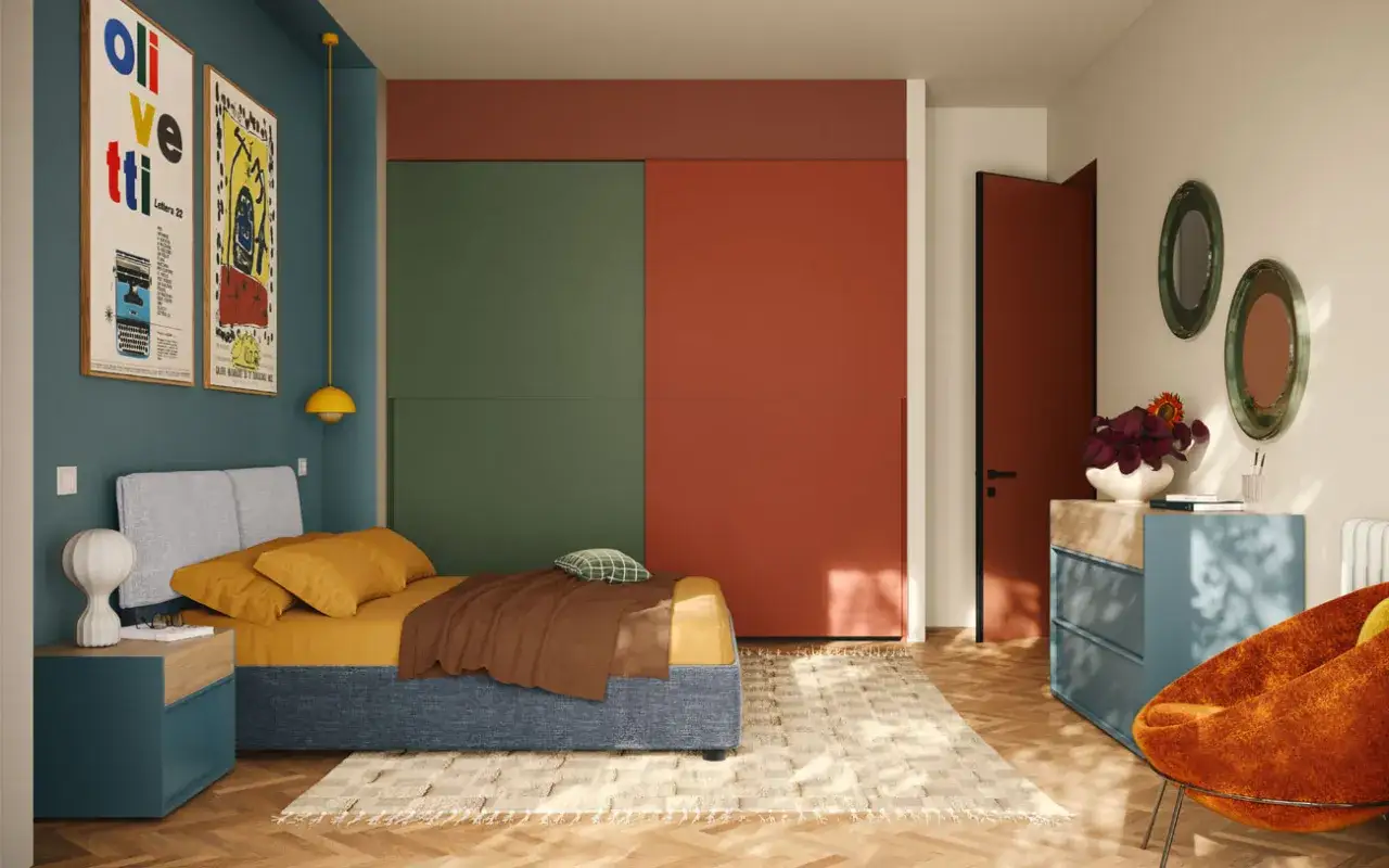 Camera da letto con armadio a pannelli verdi e rossi, letto blu, comodino e cassettiera blu.