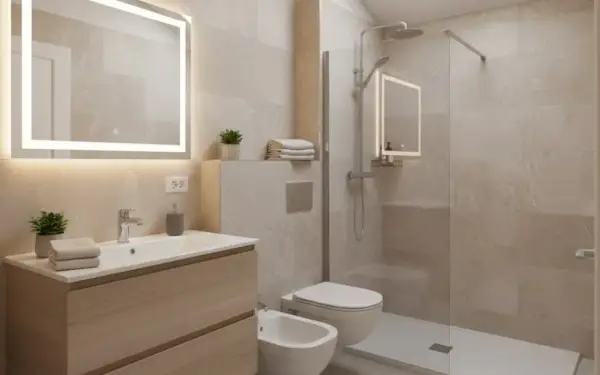 Bagno moderno con lavabo, bidet e doccia. Un secondo bagno piccolissimo, ma funzionale, con specchio illuminato e finiture in legno chiaro.