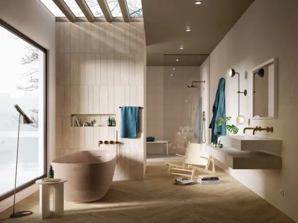 Bagno moderno con vasca freestanding, doccia a vista e lavabo sospeso. Le pareti sono rivestite con piastrelle che creano un effetto materico, quasi come se si stesse incollare piastrelle su piastrelle bagno.